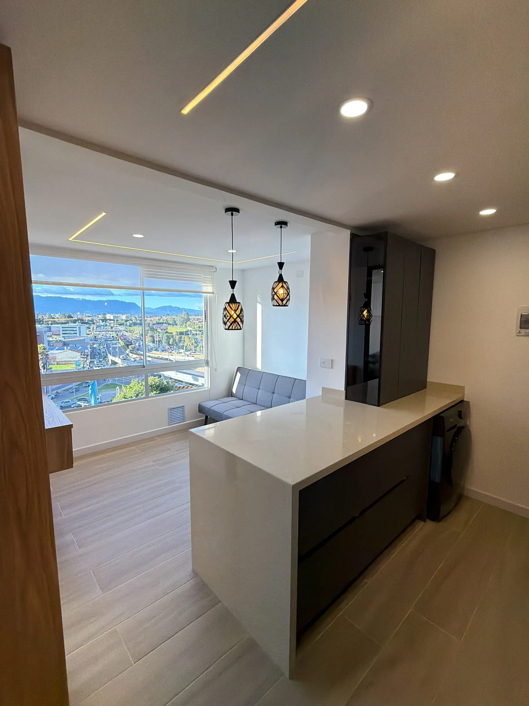 Barra y frente de cocina en relación directa con la sala.